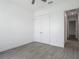 Bedroom featuring a ceiling fan, hardwood floors, and closet with white double doors at 4370 County Road 121D, Wildwood, FL 34785