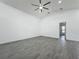 Large bedroom with high ceilings, neutral paint, and luxury vinyl plank flooring at 4370 County Road 121D, Wildwood, FL 34785
