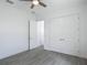 Bedroom featuring a ceiling fan, hardwood floors, and closet with white double doors at 4370 County Road 121D, Wildwood, FL 34785