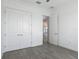Neutral bedroom features large closet, natural light and hardwood style flooring at 4370 County Road 121D, Wildwood, FL 34785