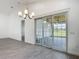 Dining area with sliding doors, chandelier lighting and views of the outside at 4370 County Road 121D, Wildwood, FL 34785