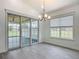 Dining room features sliding glass doors to back patio and modern chandelier at 4370 County Road 121D, Wildwood, FL 34785
