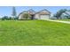 Gorgeous exterior view of home with attractive stone details and well-maintained lawn at 4370 County Road 121D, Wildwood, FL 34785