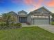 Beautiful single-Gathering home with stone accents, well-maintained landscaping, and a two-car garage at 4370 County Road 121D, Wildwood, FL 34785