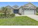 Beautiful single-story home with stone accents, manicured lawn, and a two-car garage at 4370 County Road 121D, Wildwood, FL 34785