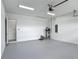 Clean and spacious garage with epoxy flooring, a water heater, and an electrical panel at 4370 County Road 121D, Wildwood, FL 34785