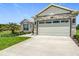Charming home showcases a spacious two-car garage and meticulously maintained landscaping at 4370 County Road 121D, Wildwood, FL 34785