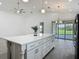 Spacious white kitchen island with plenty of storage and counter space in open floor plan at 4370 County Road 121D, Wildwood, FL 34785