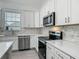 Close up of kitchen featuring stainless steel appliances, quartz countertops and decorative backsplash at 4370 County Road 121D, Wildwood, FL 34785