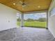 Spacious lanai featuring a tongue-and-groove ceiling, ceiling fan, and picturesque views at 4370 County Road 121D, Wildwood, FL 34785