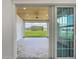 Relaxing lanai with wood ceiling, tile flooring, and beautiful backyard views at 4370 County Road 121D, Wildwood, FL 34785
