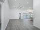 Bright and spacious living room with vaulted ceilings and luxury vinyl plank flooring at 4370 County Road 121D, Wildwood, FL 34785