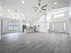Open-concept living room and kitchen featuring vaulted ceilings and luxury vinyl plank flooring at 4370 County Road 121D, Wildwood, FL 34785