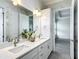 Bright main bathroom featuring double sink vanity with quartz countertops at 4370 County Road 121D, Wildwood, FL 34785