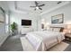 A bright main bedroom features tray ceilings, large windows, and a comfortable king-sized bed at 4370 County Road 121D, Wildwood, FL 34785