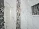 Modern shower with luxury fixtures and stylish stone tile in alcove at 4370 County Road 121D, Wildwood, FL 34785