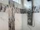 Luxury shower includes decorative tiles and a multi-setting shower panel at 4370 County Road 121D, Wildwood, FL 34785