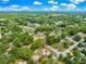 High angle view of a well maintained home with mature trees, nestled in a quiet neighborhood at 4880 Ne 23 Ave, Ocala, FL 34479