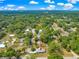 Expansive aerial view of a charming single-story home nestled among mature trees in a quiet neighborhood at 4880 Ne 23 Ave, Ocala, FL 34479