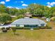 An aerial view showcases this home's location and landscaped front yard and quaint blue porch at 4880 Ne 23 Ave, Ocala, FL 34479