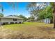Well-maintained backyard with lush green grass and storage shed at 4880 Ne 23 Ave, Ocala, FL 34479