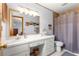 Bathroom with vanity, drawers, decorative mirror, and a combination tub and shower at 4880 Ne 23 Ave, Ocala, FL 34479
