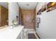 Bathroom featuring a walk-in shower with grab bar, vanity, and tile floor at 4880 Ne 23 Ave, Ocala, FL 34479