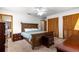 Comfortable bedroom featuring carpet flooring, a ceiling fan, and closet for storage at 4880 Ne 23 Ave, Ocala, FL 34479