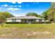 Charming one-story home with a well-maintained lawn and manicured hedges providing curb appeal at 4880 Ne 23 Ave, Ocala, FL 34479