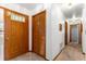 Entryway and hallway featuring neutral tones, natural wood doors, and tile flooring at 4880 Ne 23 Ave, Ocala, FL 34479