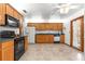 Open kitchen with wooden cabinets, granite counters, and tile floors at 4880 Ne 23 Ave, Ocala, FL 34479