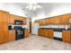 Traditional kitchen featuring wooden cabinets and black appliances at 4880 Ne 23 Ave, Ocala, FL 34479