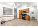 Eat-in kitchen features tile floors, wood cabinets, and black appliances at 4880 Ne 23 Ave, Ocala, FL 34479