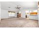 Spacious living room with vaulted ceilings and carpet flooring at 4880 Ne 23 Ave, Ocala, FL 34479