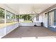 Spacious screened porch with ceiling fan provides the perfect outdoor relaxation and entertainment space at 4880 Ne 23 Ave, Ocala, FL 34479