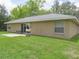 A well-maintained backyard featuring a patio, sliding glass door, and plenty of green space at 5083 Se 26Th St, Ocala, FL 34480
