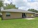An inviting backyard with a patio, sliding glass door, and a grill, perfect for outdoor entertaining at 5083 Se 26Th St, Ocala, FL 34480