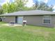 Backyard view of a single story home featuring a patio and well-kept lawn, ideal for outdoor enjoyment at 5083 Se 26Th St, Ocala, FL 34480
