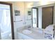 Bathroom featuring a vanity with sink, mirror, and a separate shower/tub with white tile surround at 5083 Se 26Th St, Ocala, FL 34480