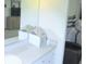 Bathroom featuring vanity with a large mirror reflecting the bedroom decor at 5083 Se 26Th St, Ocala, FL 34480
