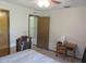 Bedroom view with a ceiling fan, showing an interior door and desk in a neutral color scheme at 5083 Se 26Th St, Ocala, FL 34480