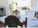 Dining room with wood table, blue tablecloth, and white kitchen in the background at 5083 Se 26Th St, Ocala, FL 34480
