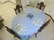 Dining room with light blue tablecloth, wooden furniture, and light flooring at 5083 Se 26Th St, Ocala, FL 34480