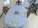 Dining room has a round table, blue table cloth, and wooden chairs at 5083 Se 26Th St, Ocala, FL 34480