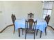 Dining room with wood furniture, blue tablecloth, window for natural lighting, and light colored flooring at 5083 Se 26Th St, Ocala, FL 34480