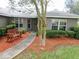 Inviting front entrance with a charming bench, manicured shrubs and a mulch bed enhance the curb appeal at 5083 Se 26Th St, Ocala, FL 34480