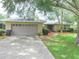 Charming single-story home with a two-car garage and walkway to the front door at 5083 Se 26Th St, Ocala, FL 34480