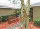 Home's inviting entrance with a charming bench, providing a welcoming and aesthetic appeal at 5083 Se 26Th St, Ocala, FL 34480