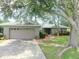 This home has a well-manicured lawn, mature trees, and a charming bench which enhances its curb appeal at 5083 Se 26Th St, Ocala, FL 34480