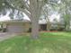 Well-maintained single-story home featuring a manicured lawn, inviting entrance, and an attached garage at 5083 Se 26Th St, Ocala, FL 34480